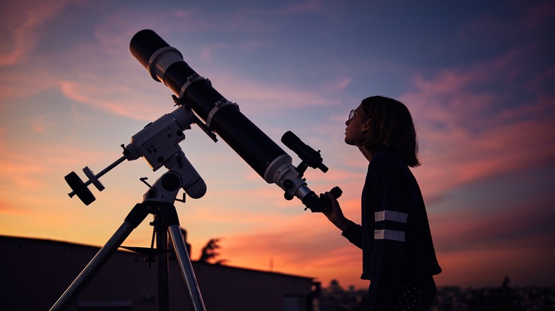 young woman with telescope