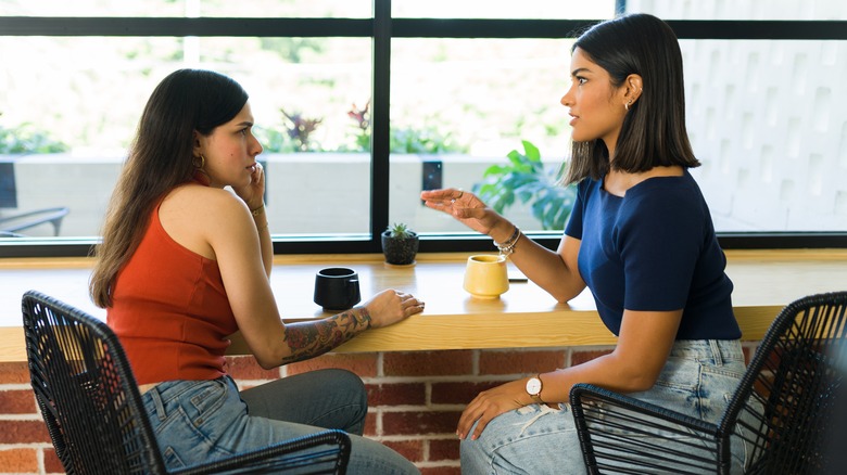 two friends talking in cafe