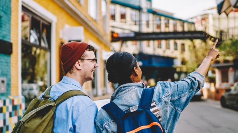 Couple with backpacks in a city