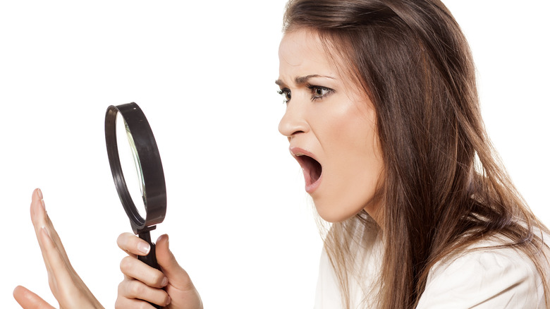 woman shocked looking at nails