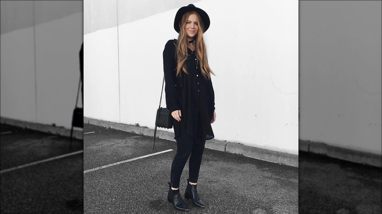 Model wearing black ankle boots