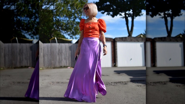 Woman wearing purple satin maxi skirt