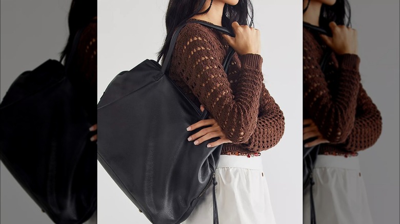 Model with black oversized tote