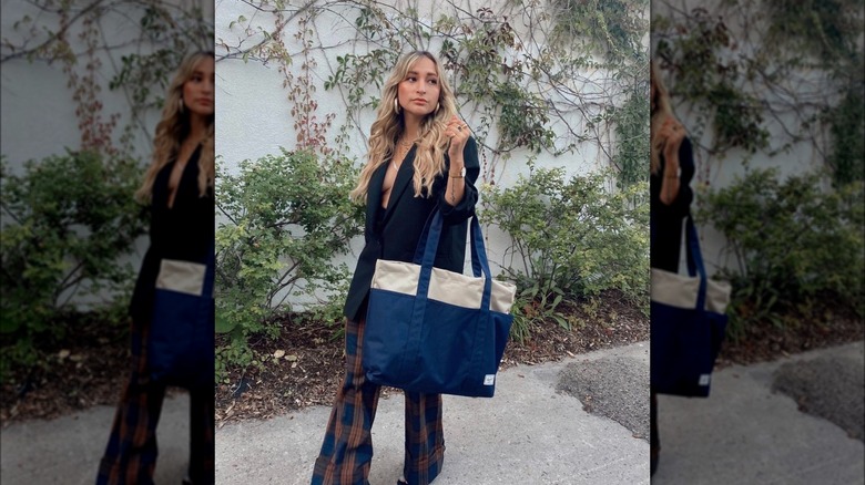 Woman posing with navy tote