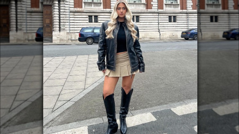Woman poses in miniskirt and knee-high boots
