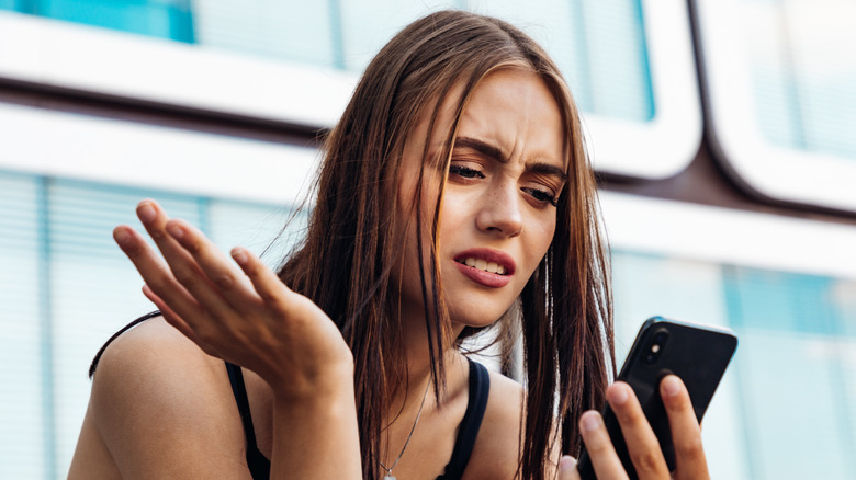 angry woman holding phone