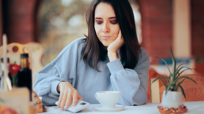 woman putting down phone