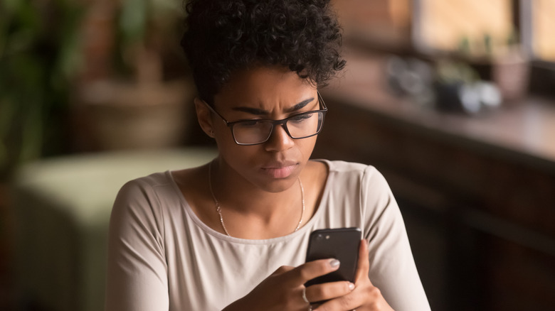 woman holding cellphone 