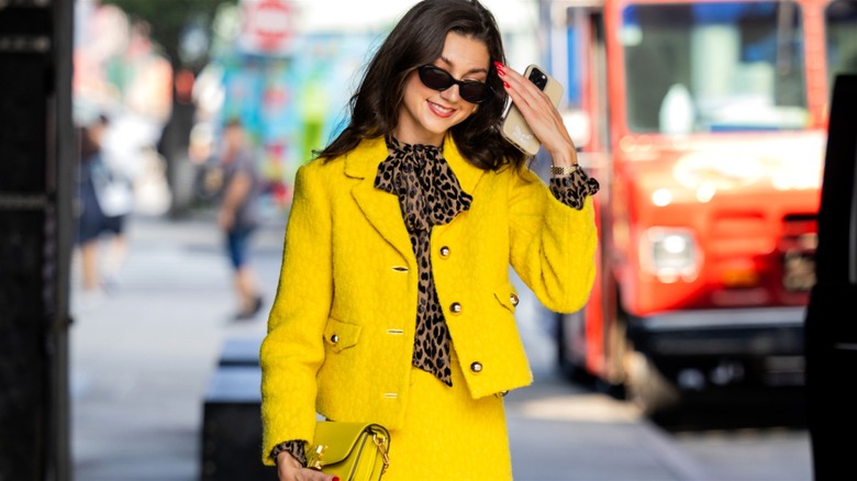 Woman wearing yellow suit and leopard-print blouse