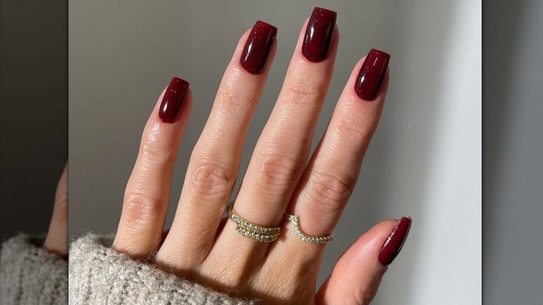 woman with maroon nails