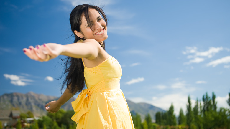 woman in yellow dress smiling