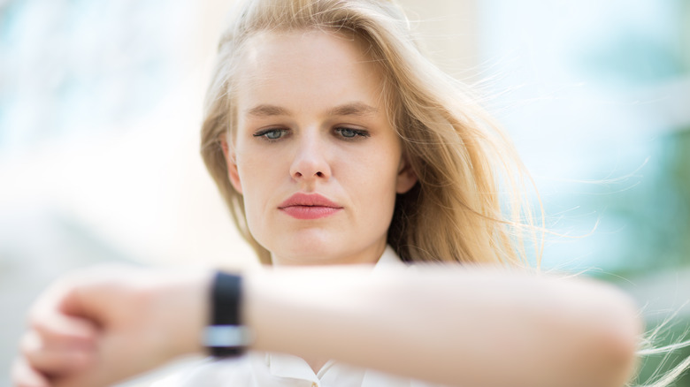 woman looking at her watch