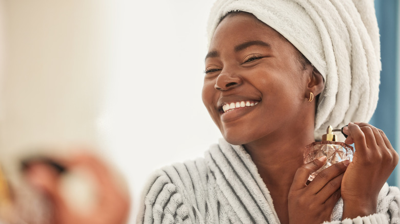 person applying perfume