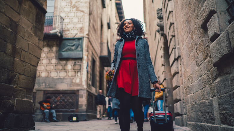 Woman smiles strolling through city