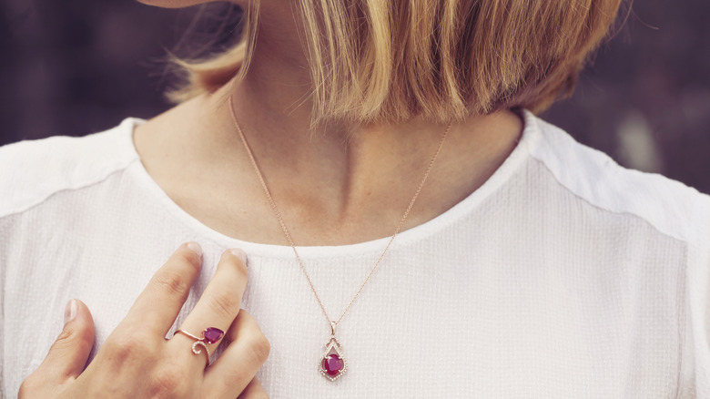 woman wearing ruby necklace and ring