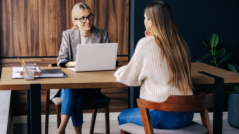 Woman is interviewed at desk