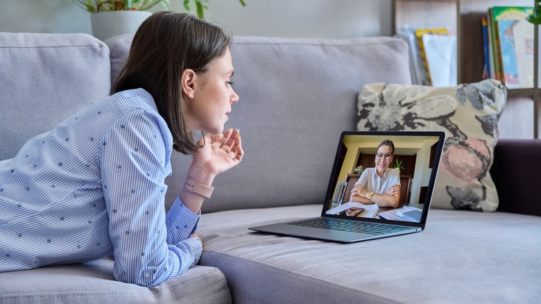 woman leaning towards laptop screen