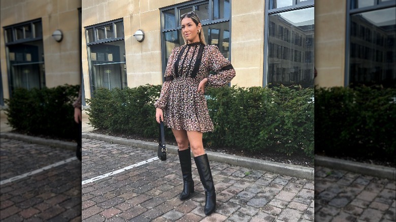 Girl wearing a black floral dress.