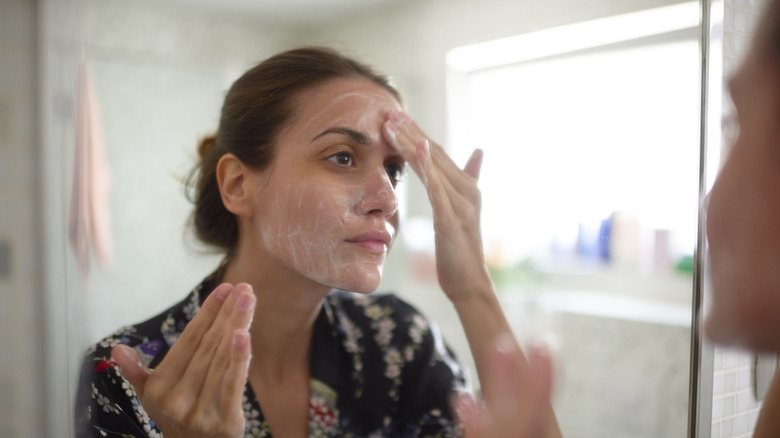 woman washing her face