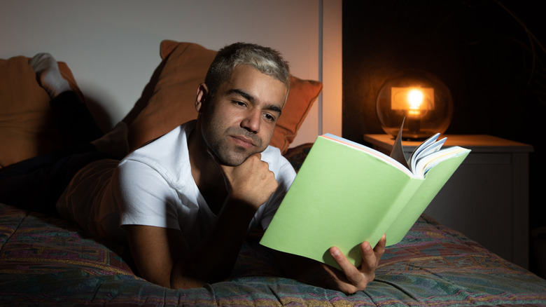 man reading in bed