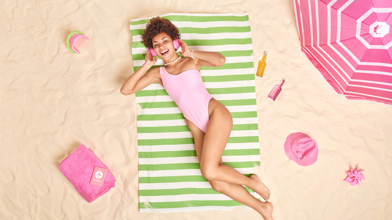 woman beach towel on sand