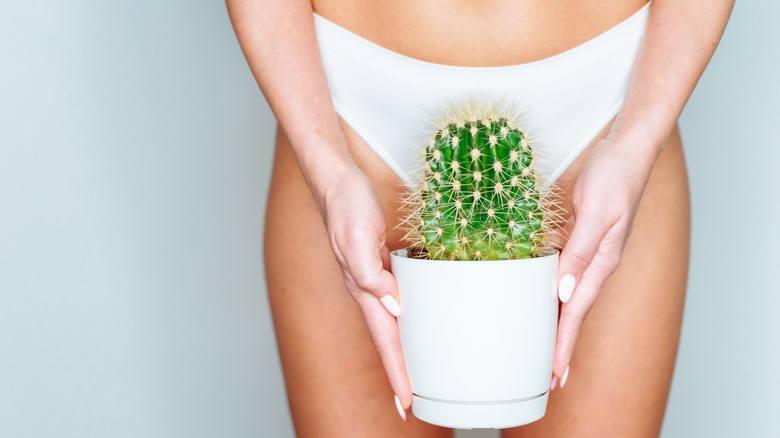 woman holding cactus