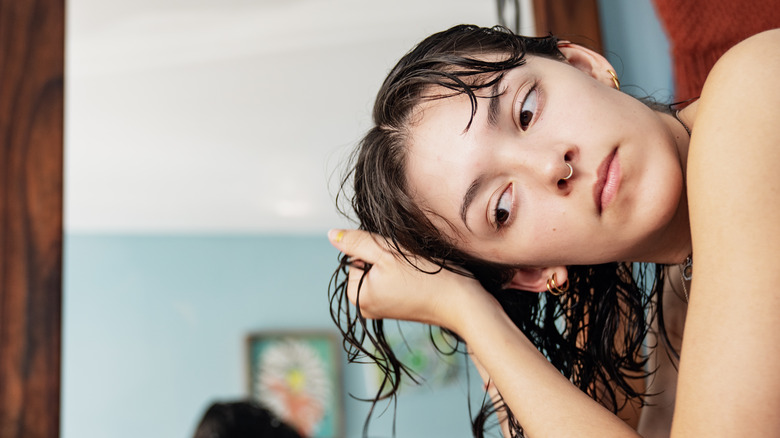 A woman air drying her hair