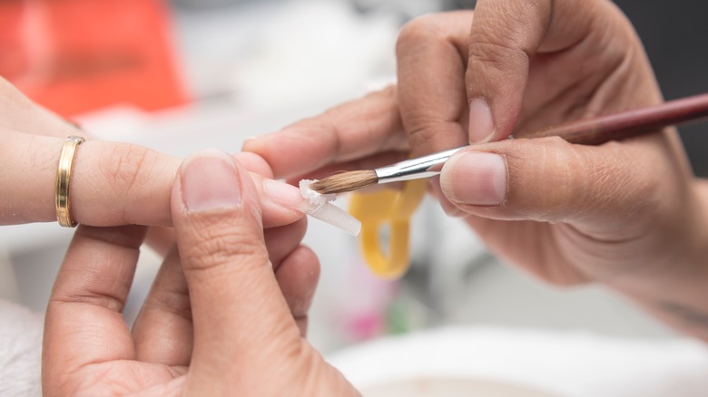 applying acrylic on nails