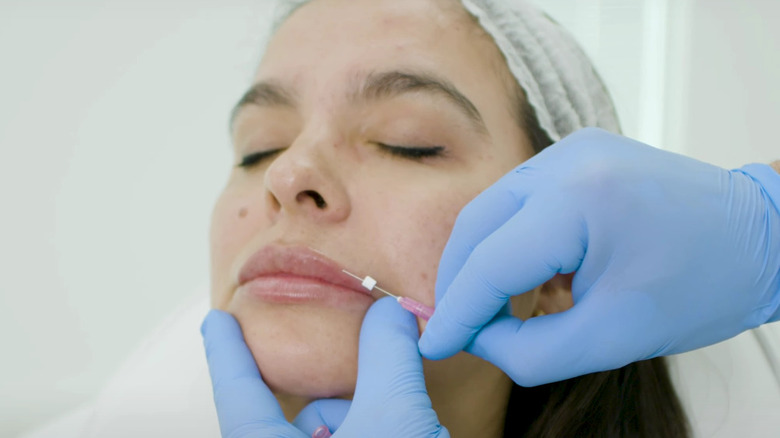 woman getting a lip threading procedure 