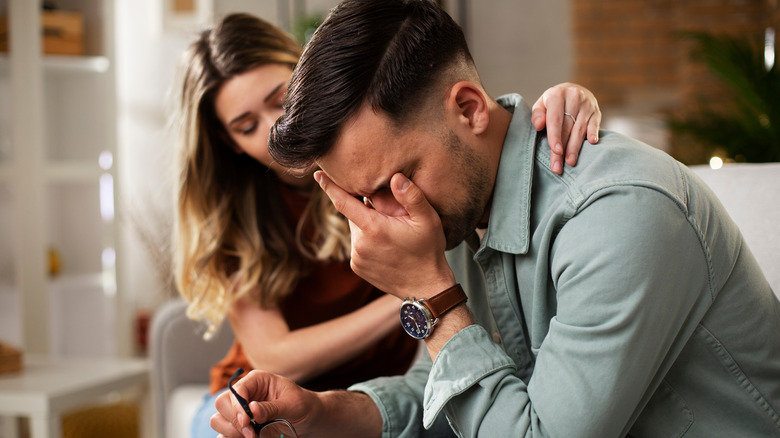 woman comforting crying man