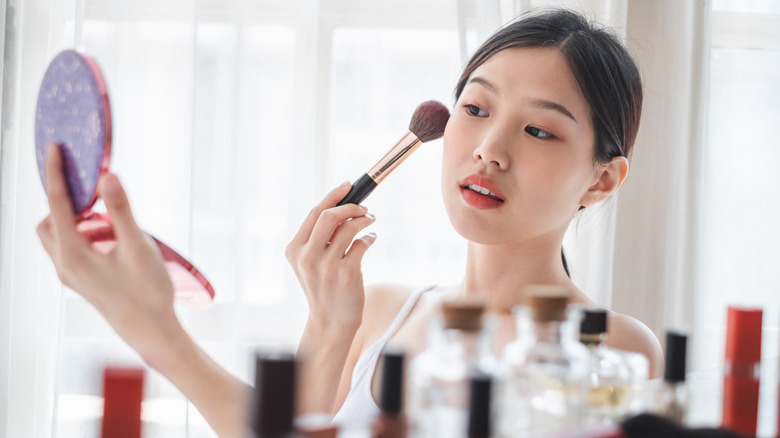 woman applying powder