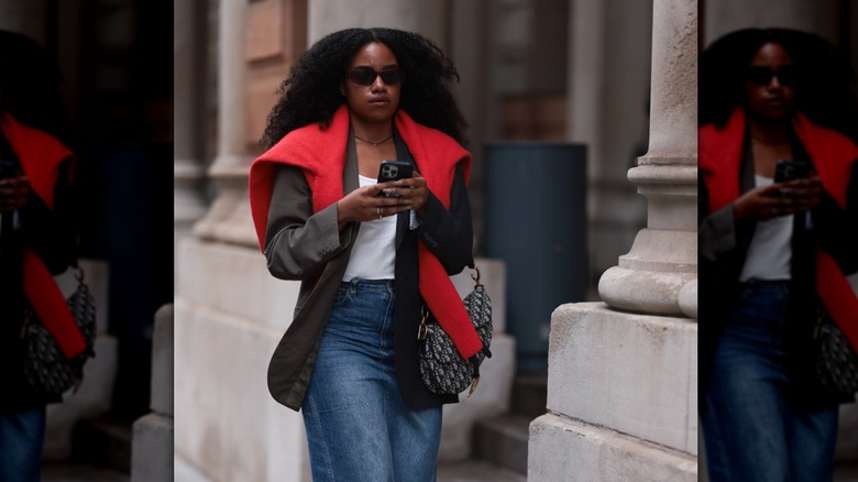 woman wearing sweater around shoulders