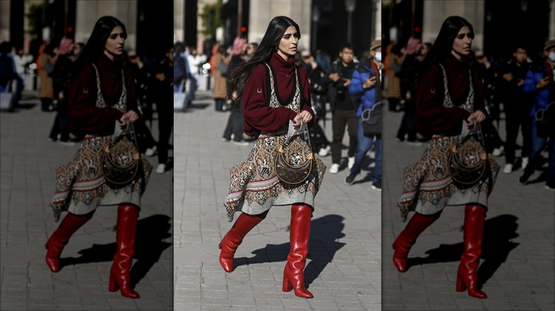 woman wearing dress over sweater