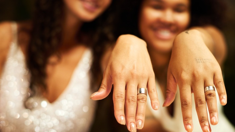 couple showing off engagement rings