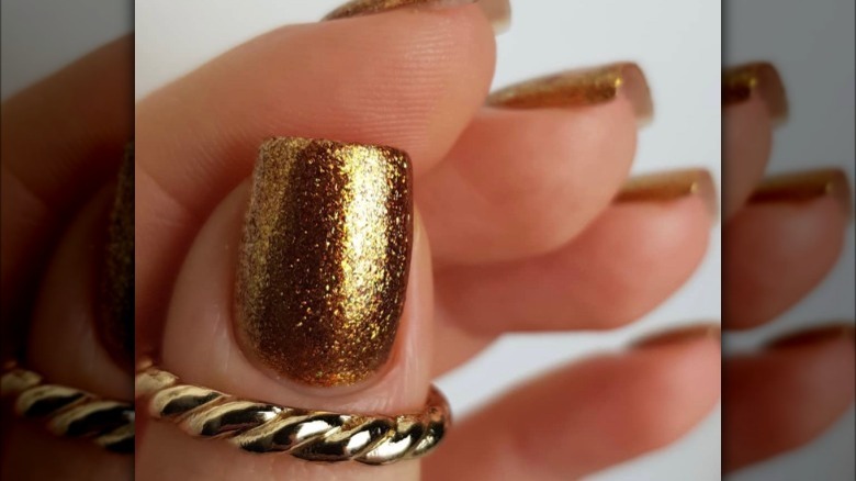 Glittery gold nail polish 