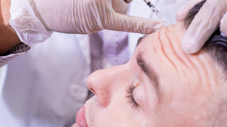 man getting Botox on forehead