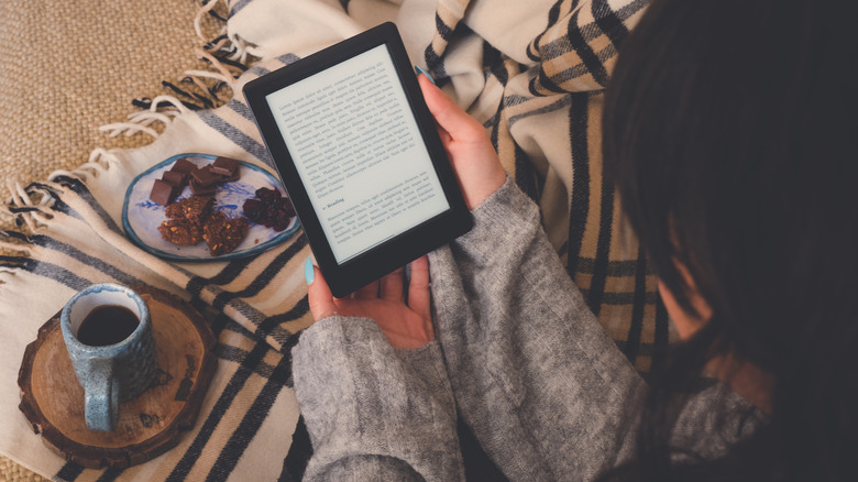 Cozy woman reading her Kindle