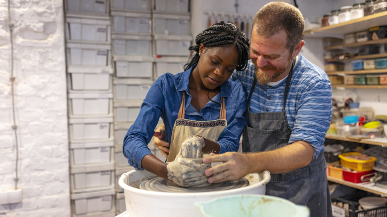 Couple taking pottery class