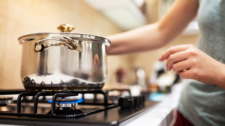 woman boiling pot of water