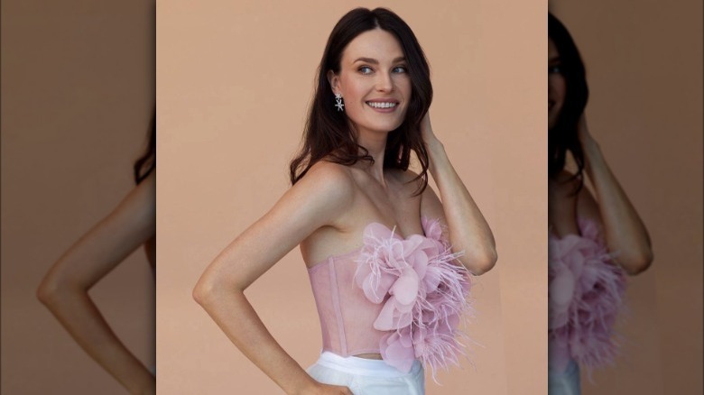 Model wearing rosette bandeau top