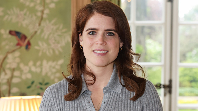 Princess Eugenie wearing a gray sweater with dark eyeliner