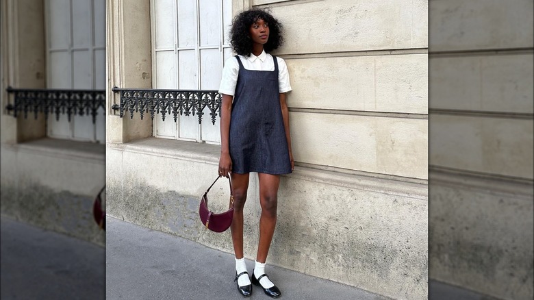 Woman wearing minidress, socks, Mary Janes