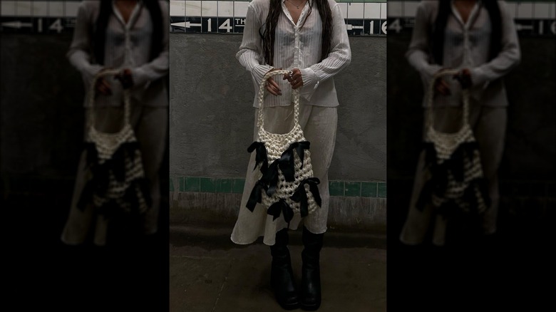 Person carrying woven tote with bows