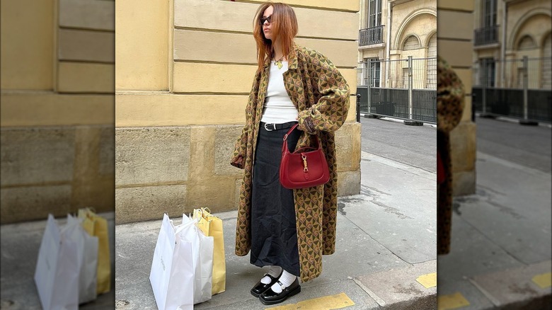 Woman wearing patterned trenchcoat, Mary Janes