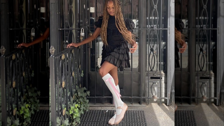 Woman in pink Mary Janes, knee-high socks