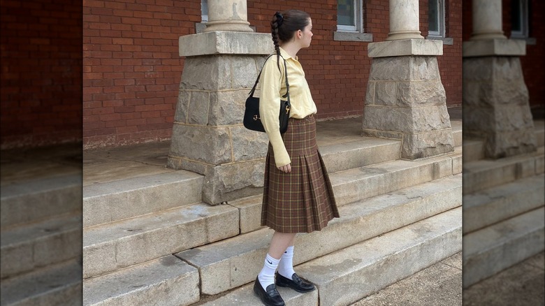 Girl wearing plaid pleated skirt 