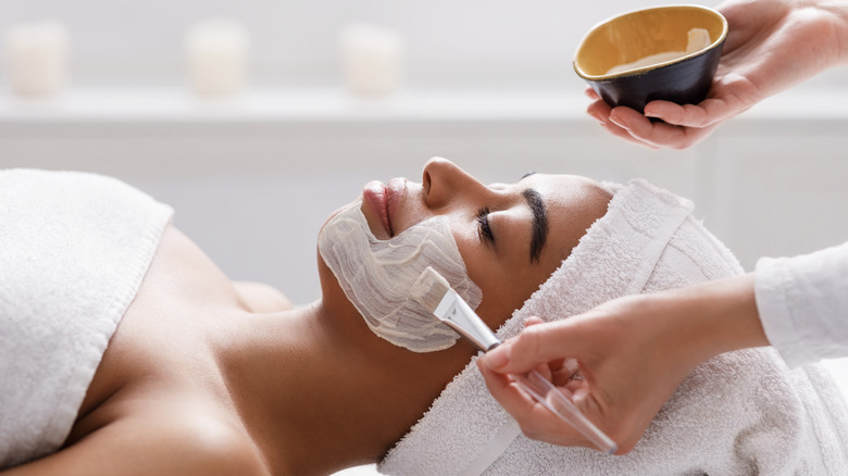 skin esthetician applying mask on client