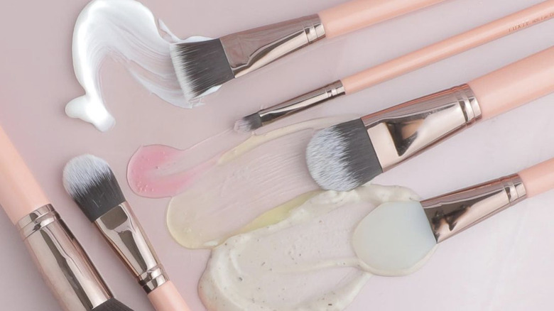 brushes spreading skincare products 