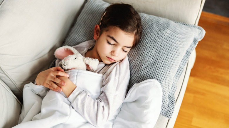 young girl hugging stuffed bunny