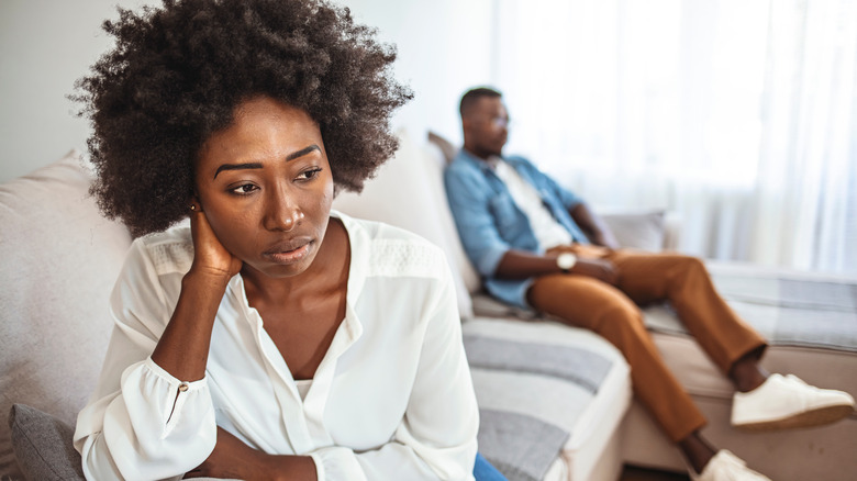 unhappy couple on sofa